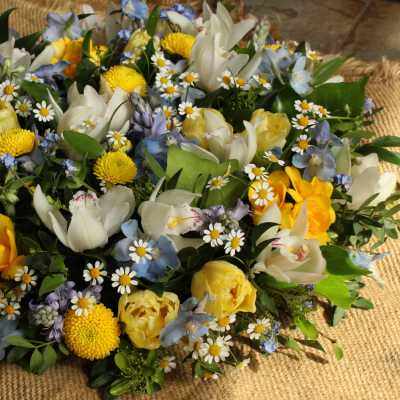 Springlike Posy - Funeral posy arrangement in spring-like shades of blue, yellow and white.