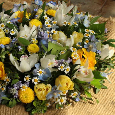 Springlike Posy - Posy arrangement in springlike shades of blue, yellow and white.  Please note this arrangement is made with seasonal flowers and foliage and will vary from the photograph depending on availability. However, the colours and style will remain the same.