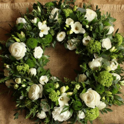 Simplicity Wreath - An elegant selection of white and green flowers and foliage, arranged in a traditional wreath.