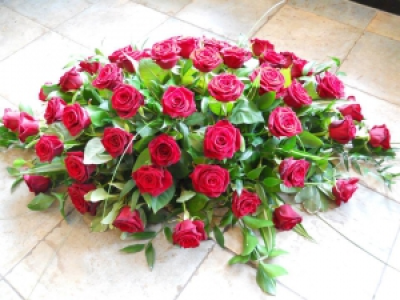 Rose Casket Spray - Beautiful casket spray of stunning roses mixed with seasonal foliage.
