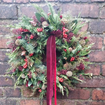 Traditional Christmas wreath - The traditional Christmas wreaths are made on a mossed frame with a beautiful, seasonal selection of foliage, berries and dried cones and finished with a luxurious festive ribbon.